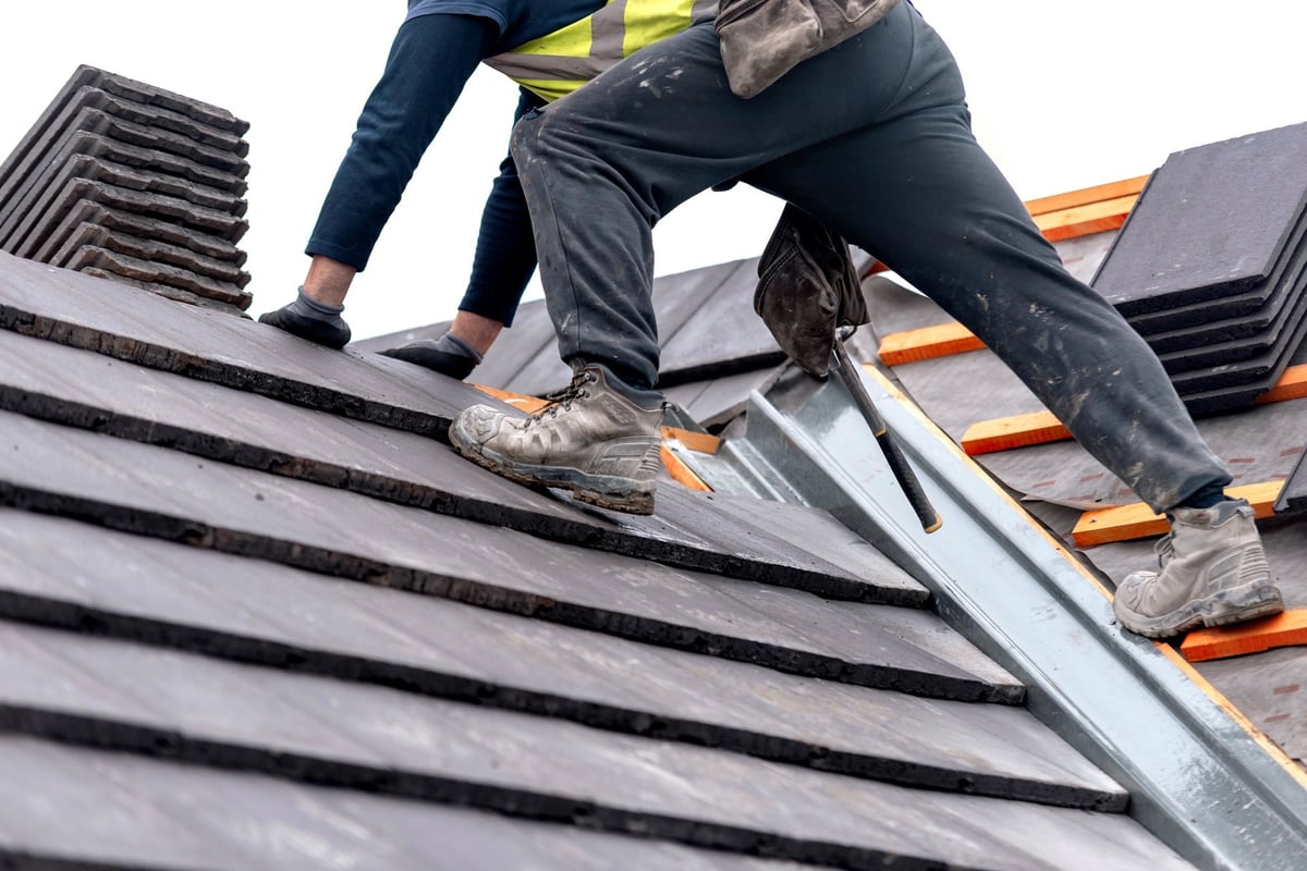 Roofing crew installing shingles on a residential home in Central Pennsylvania