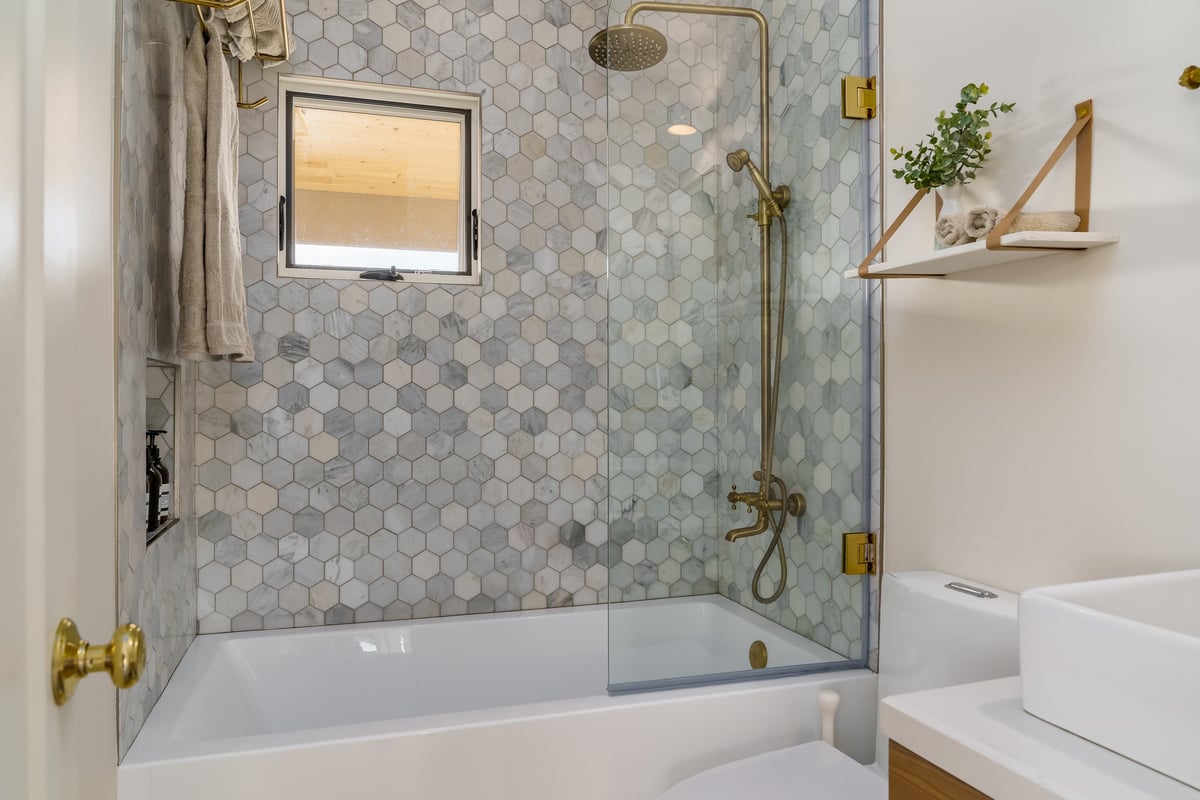 Completed bathroom renovation with walk-in tiled shower